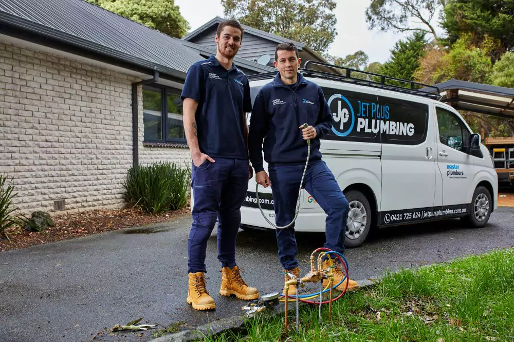 winning plumbers in front of plumbing van