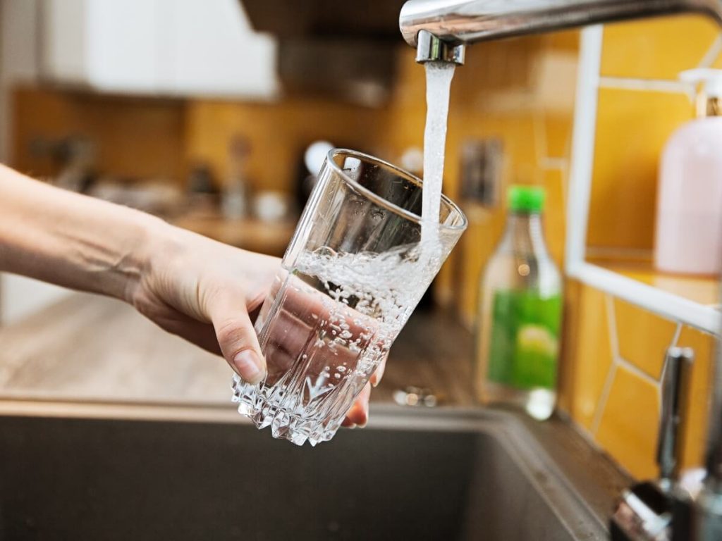 Header A Glass Being Filled With Water From A Tap